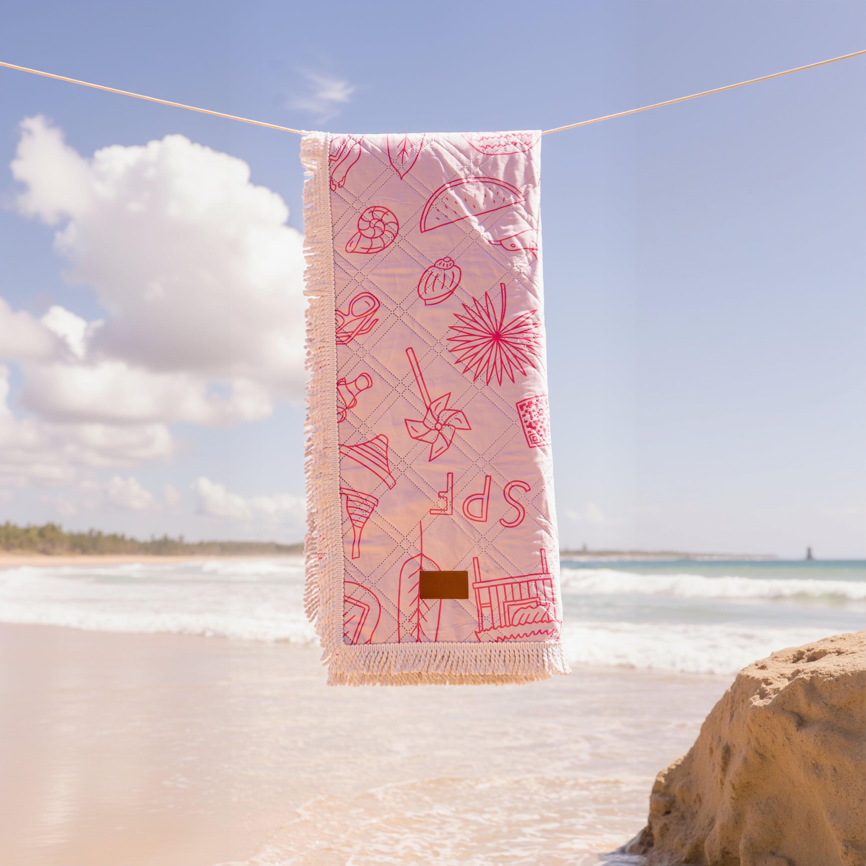 Luxurious beach picnic setup featuring an elegant beach blanket and premium picnic blanket by the seaside
