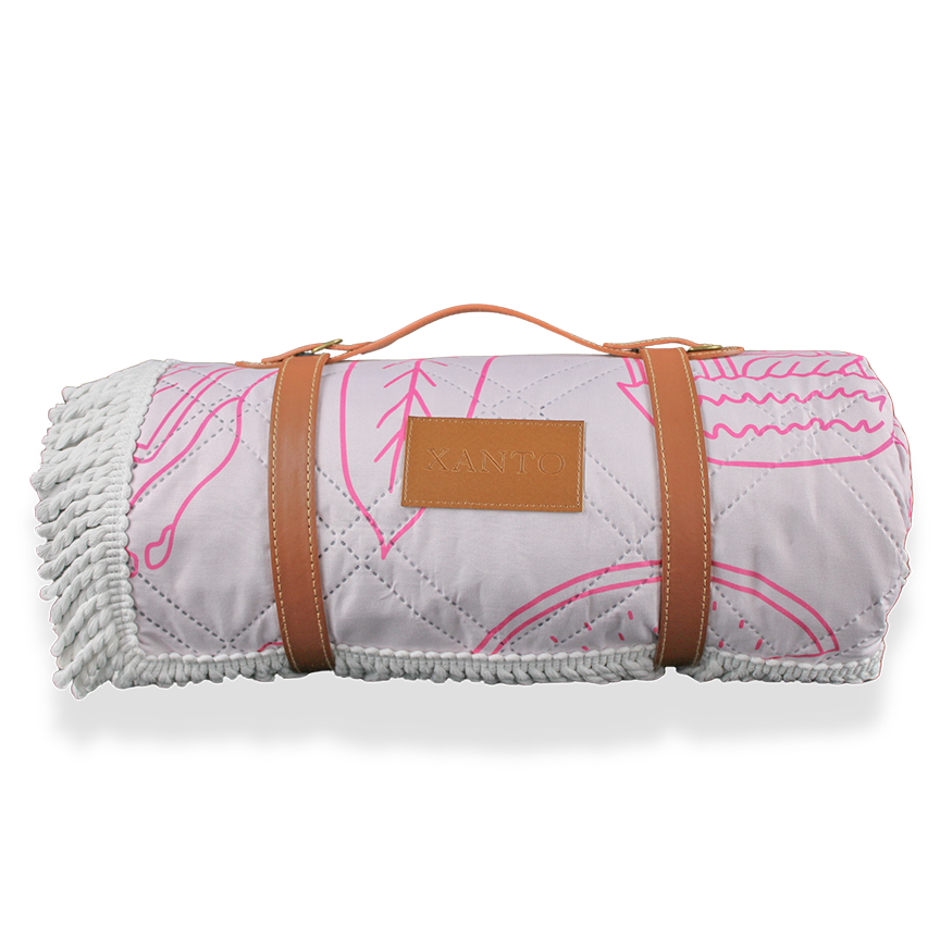Luxurious beach picnic setup featuring an elegant beach blanket and premium picnic blanket by the seaside