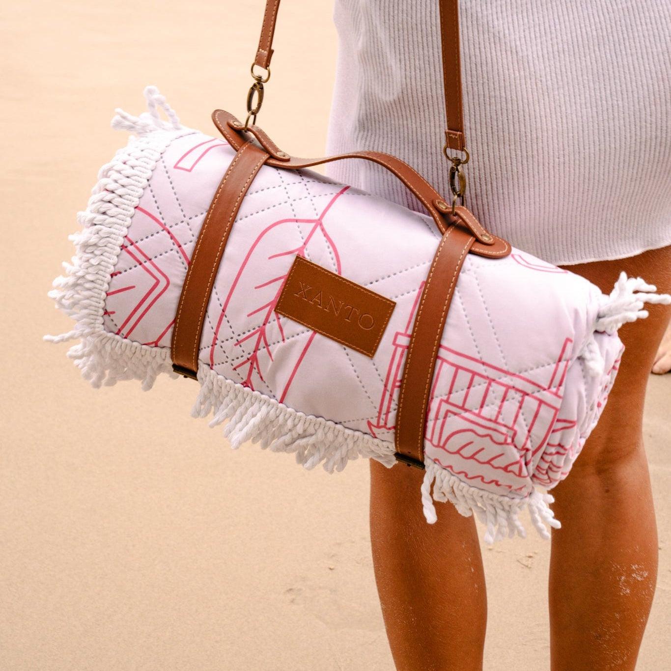Luxurious beach picnic setup featuring an elegant beach blanket and premium picnic blanket by the seaside