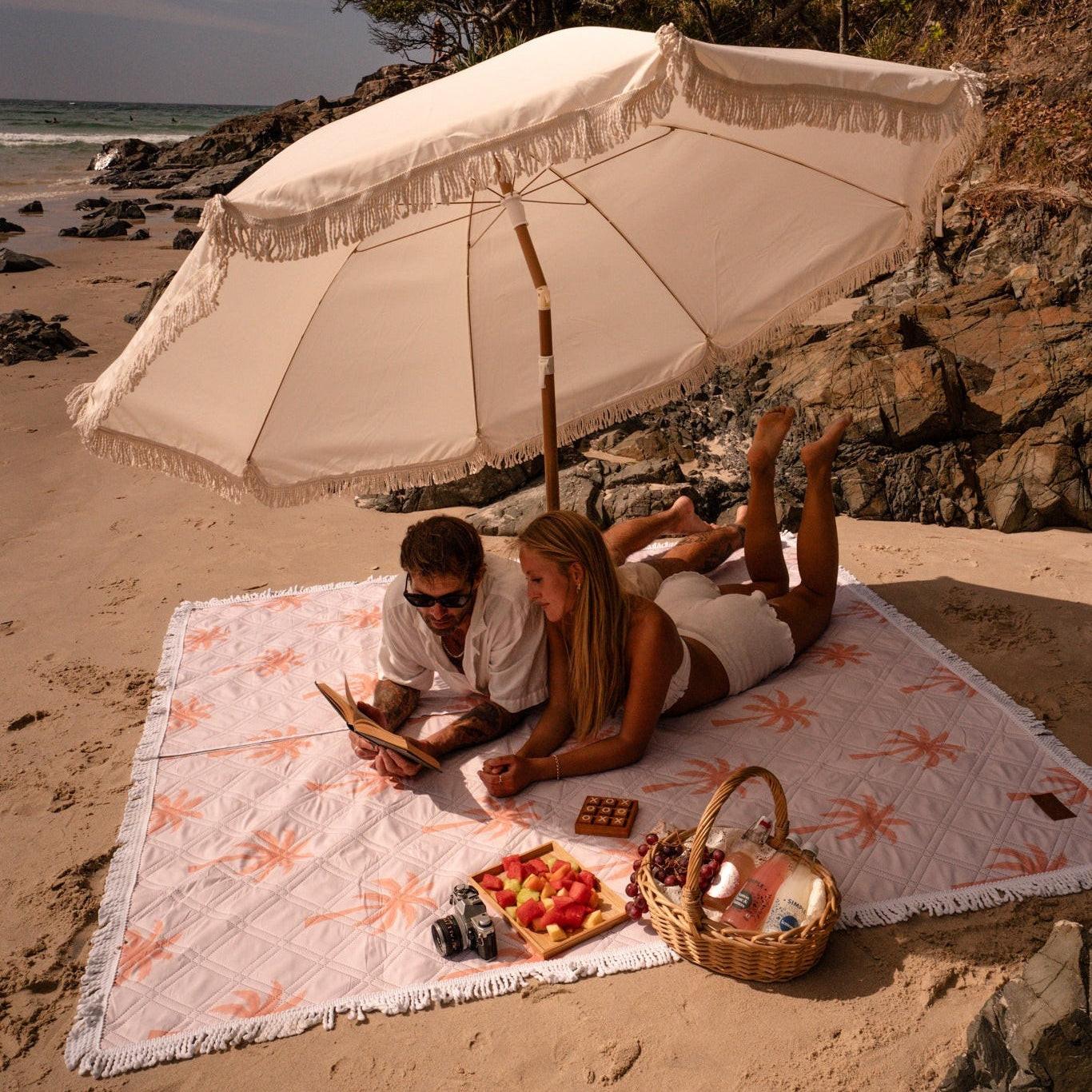 Beach picnic setup on a colorful beach blanket perfect for outdoor relaxation and enjoyment