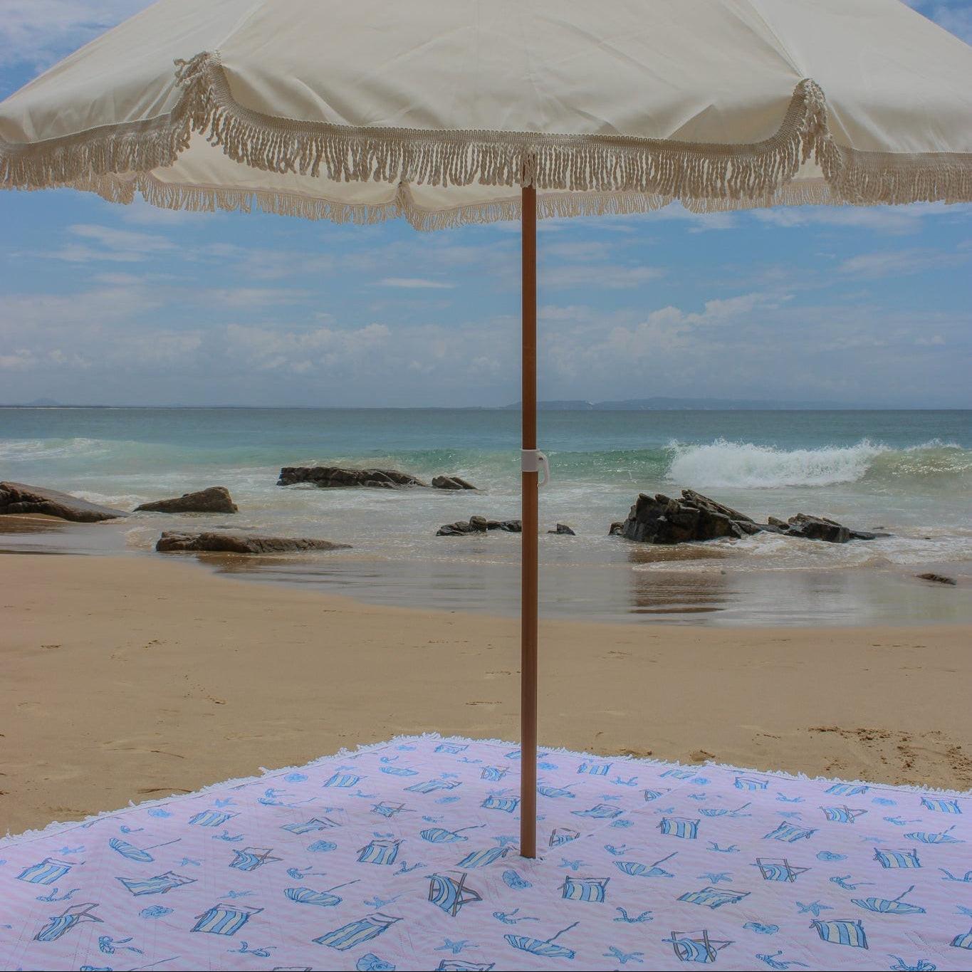Enjoy a sunny day at the beach with a cozy picnic blanket for the perfect outdoor picnic experience