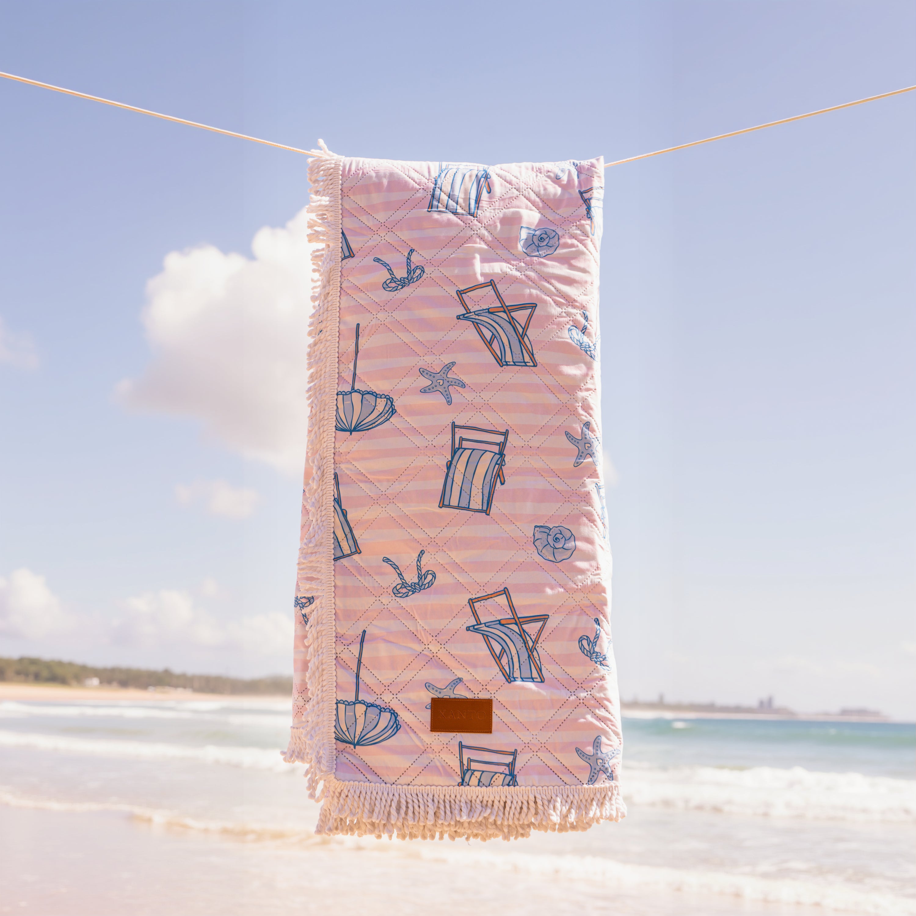 Enjoy a sunny day at the beach with a cozy picnic blanket for the perfect outdoor picnic experience