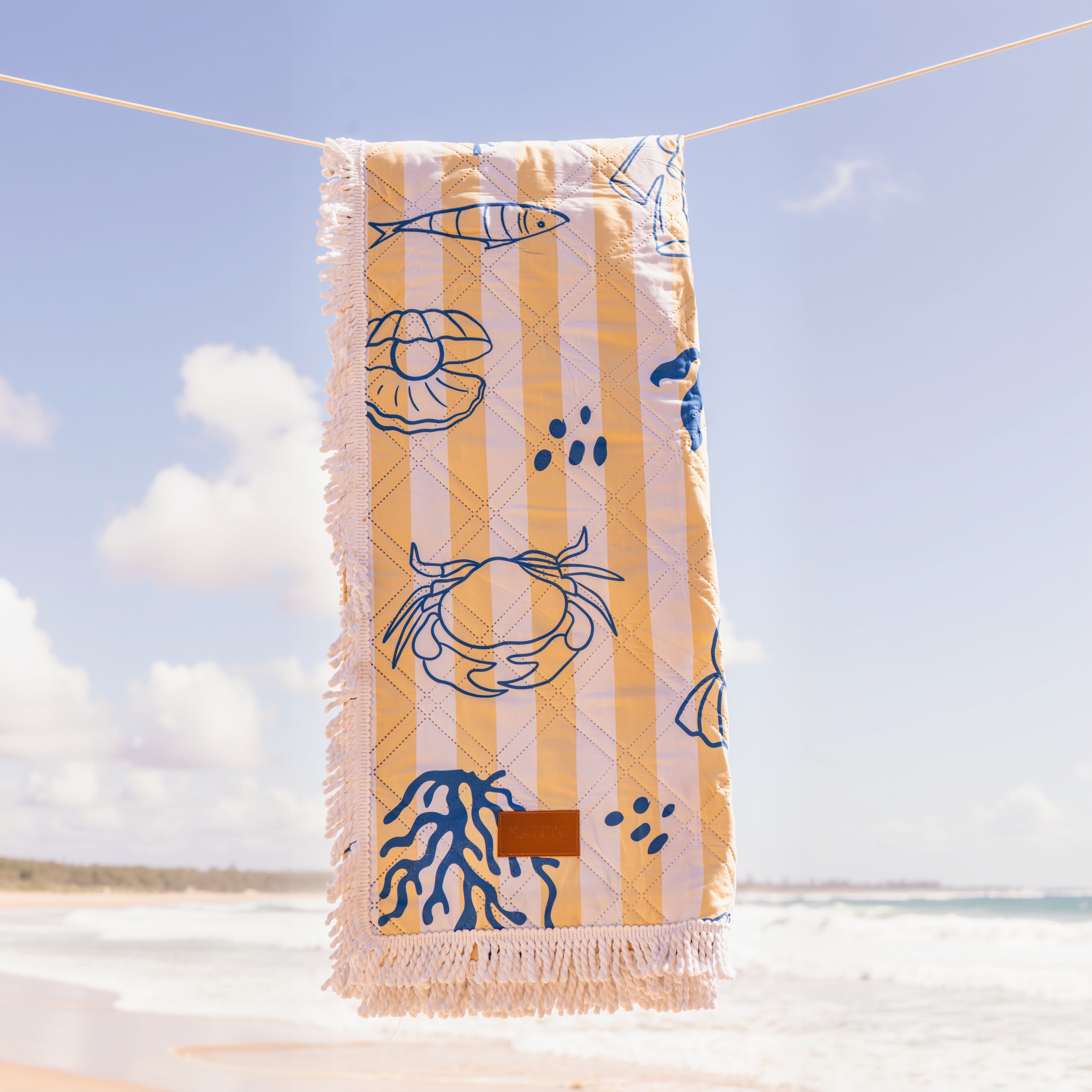 Beach picnic setup with a cozy beach blanket and colorful picnic blanket for relaxing outdoor fun