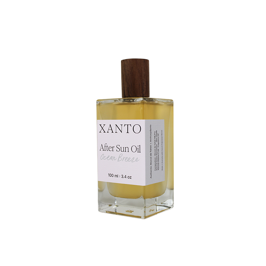 After Sun Oil bottle on beach with ocean breeze fragrance, perfect for soothing sun-kissed skin
