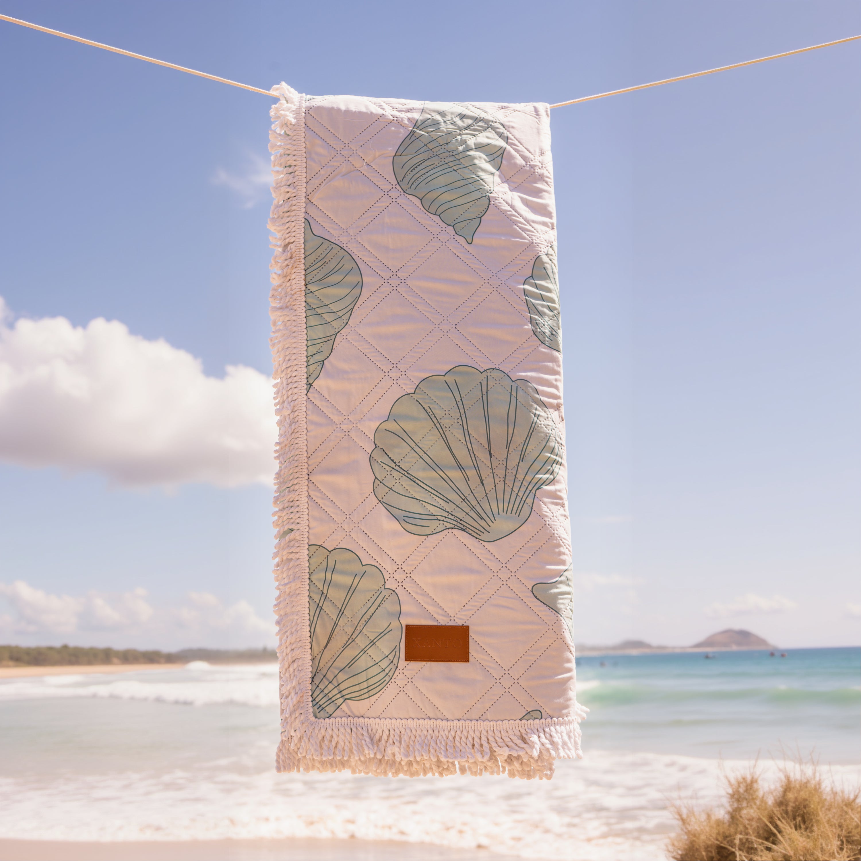 Luxury beach picnic setup featuring an elegant beach blanket and stylish picnic blanket for a perfect seaside retreat