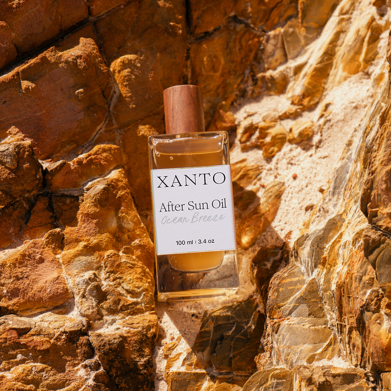 After Sun Oil bottle on beach with ocean breeze fragrance, perfect for soothing sun-kissed skin