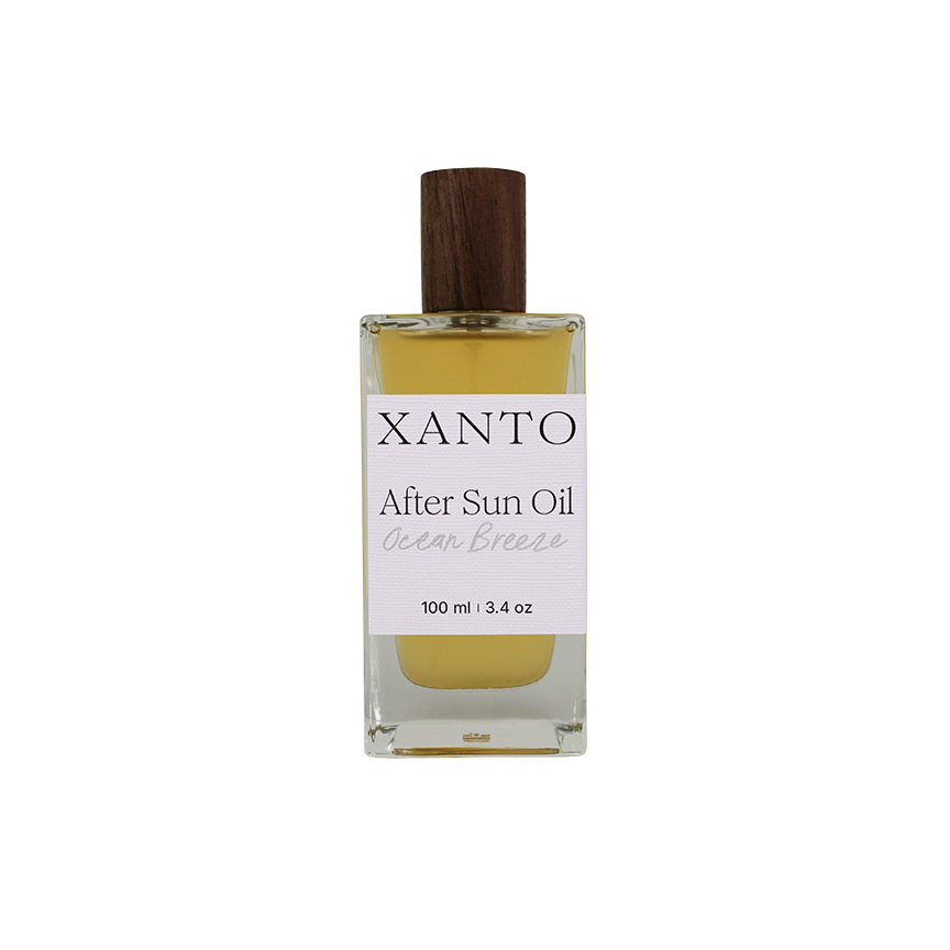 After Sun Oil bottle on beach with ocean breeze fragrance, perfect for soothing sun-kissed skin